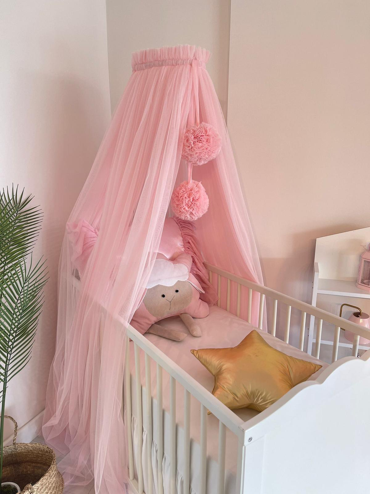pink bed canopy with pompoms