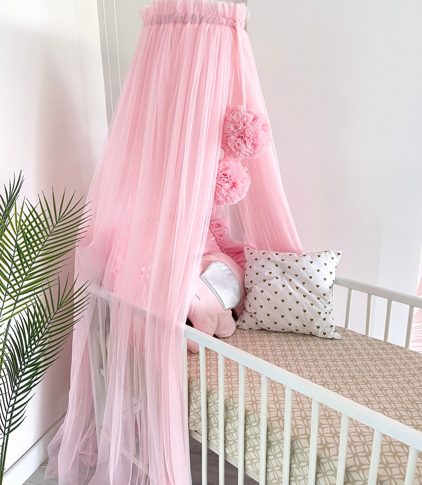 pink bed canopy with pompoms