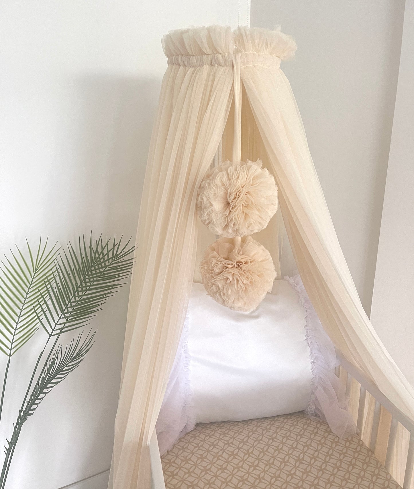 Light beige bed canopy with bobbles