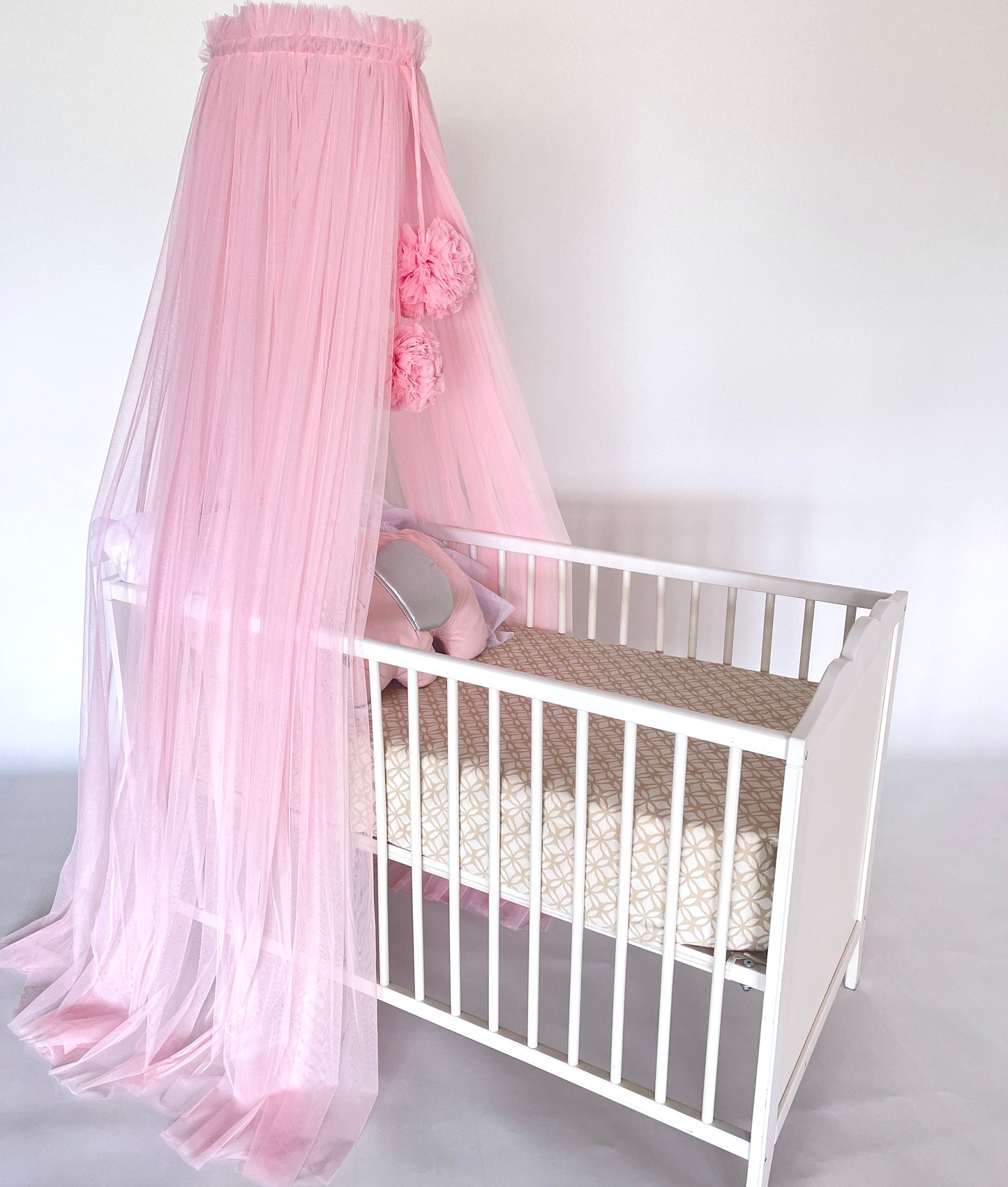 pink bed canopy with pompoms