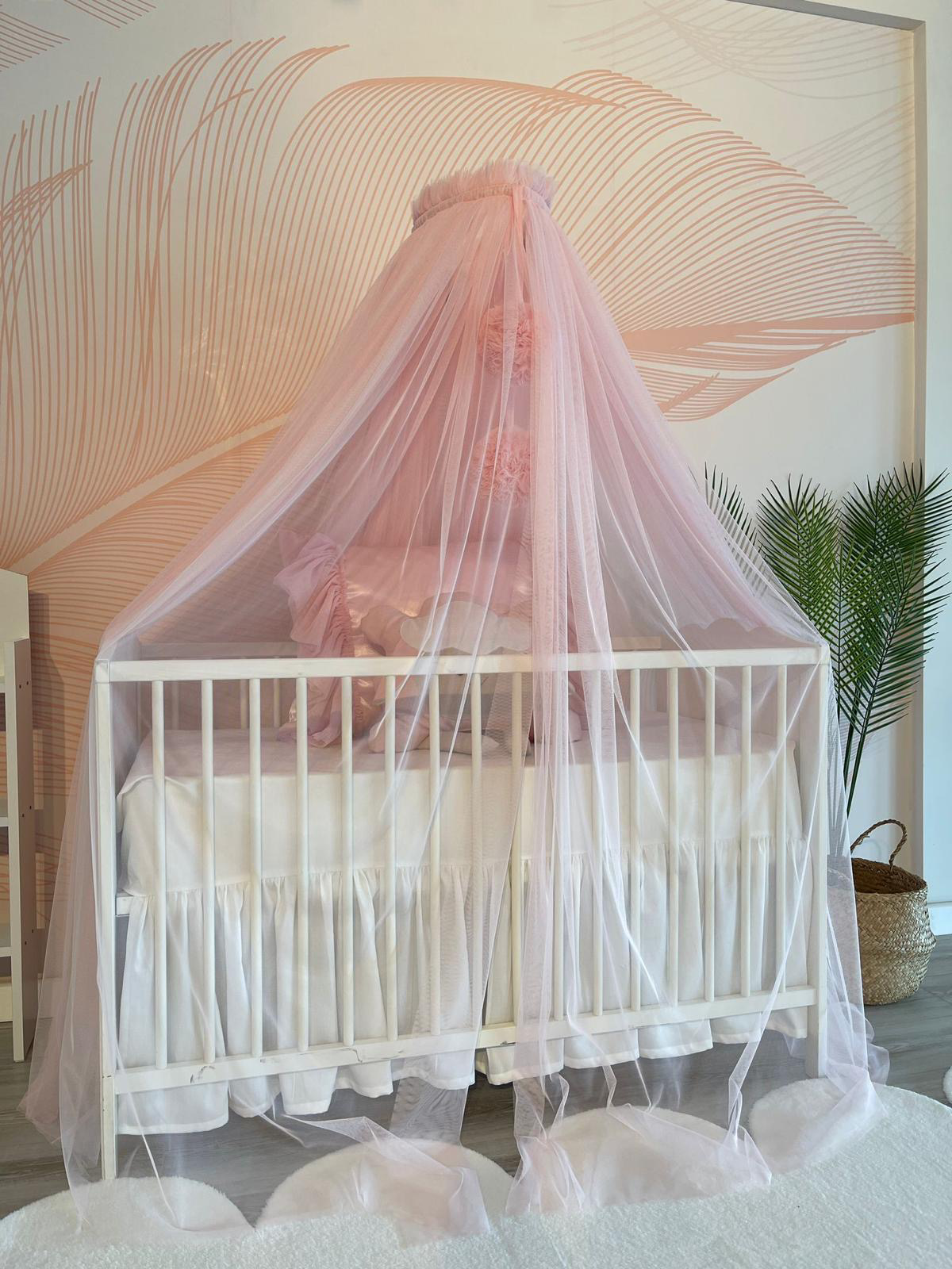 pink bed canopy with pompoms