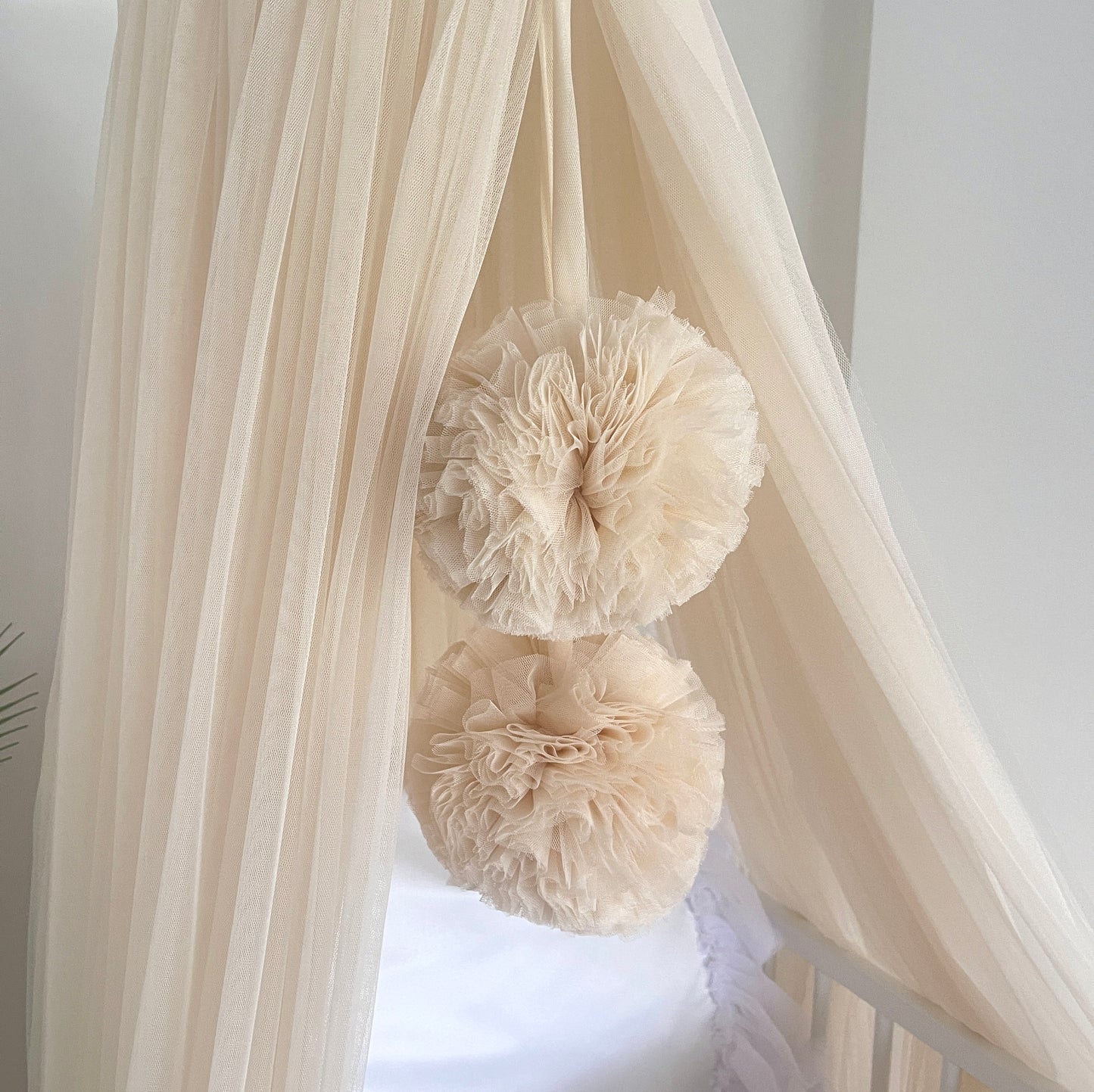 Light beige bed canopy with bobbles