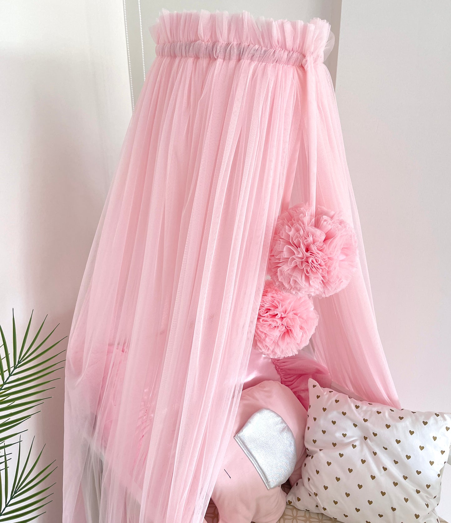 pink bed canopy with pompoms
