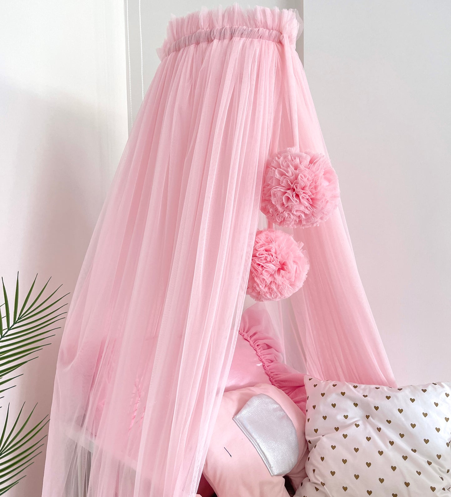 pink bed canopy with pompoms