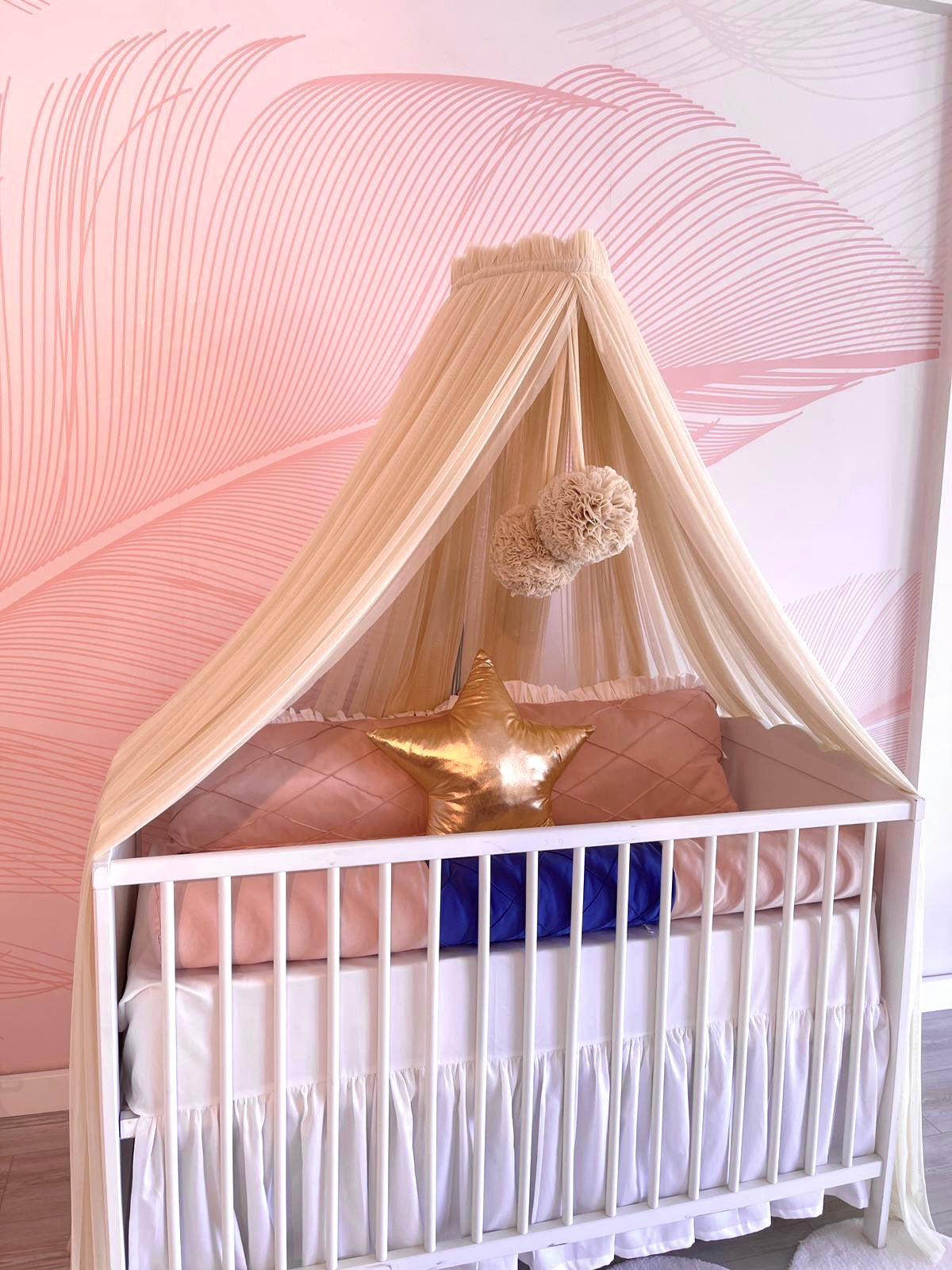 Beige bed canopy with pompoms