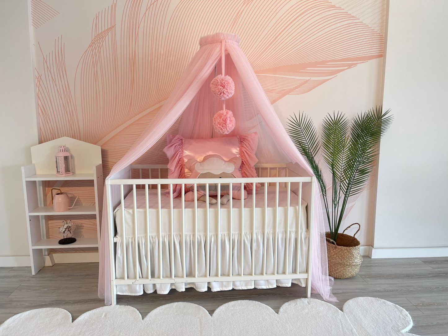 pink bed canopy with pompoms