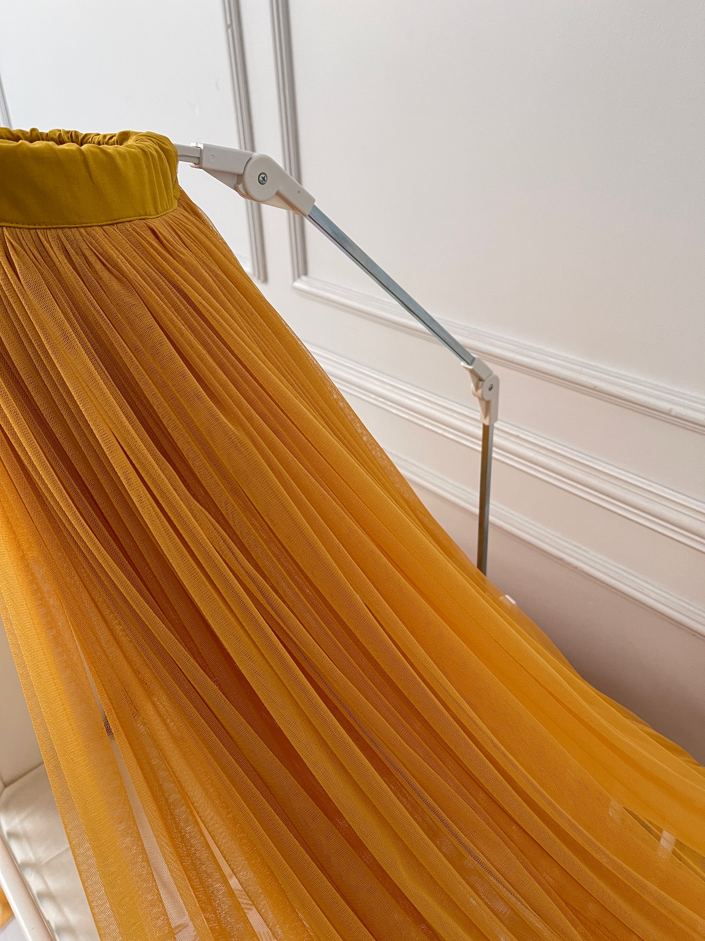 Mustard yellow bed canopy with pompom wreath