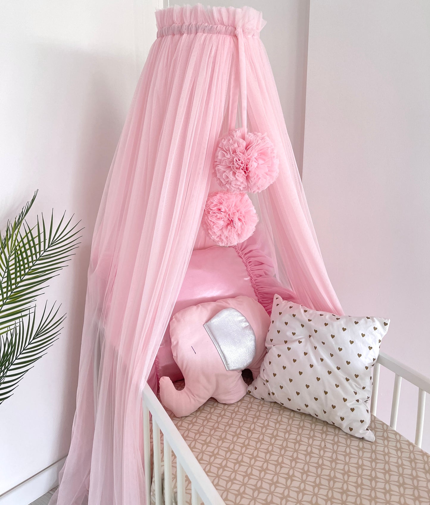 pink bed canopy with pompoms