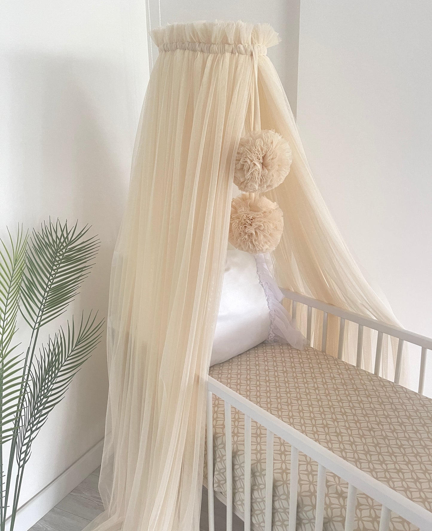 Light beige bed canopy with bobbles