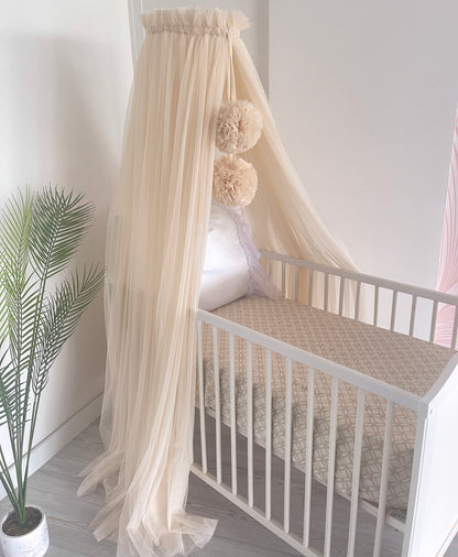 Light beige bed canopy with bobbles