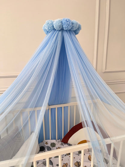 Blue bed canopy with pompom wreath