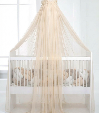 Light beige bed canopy with bobbles