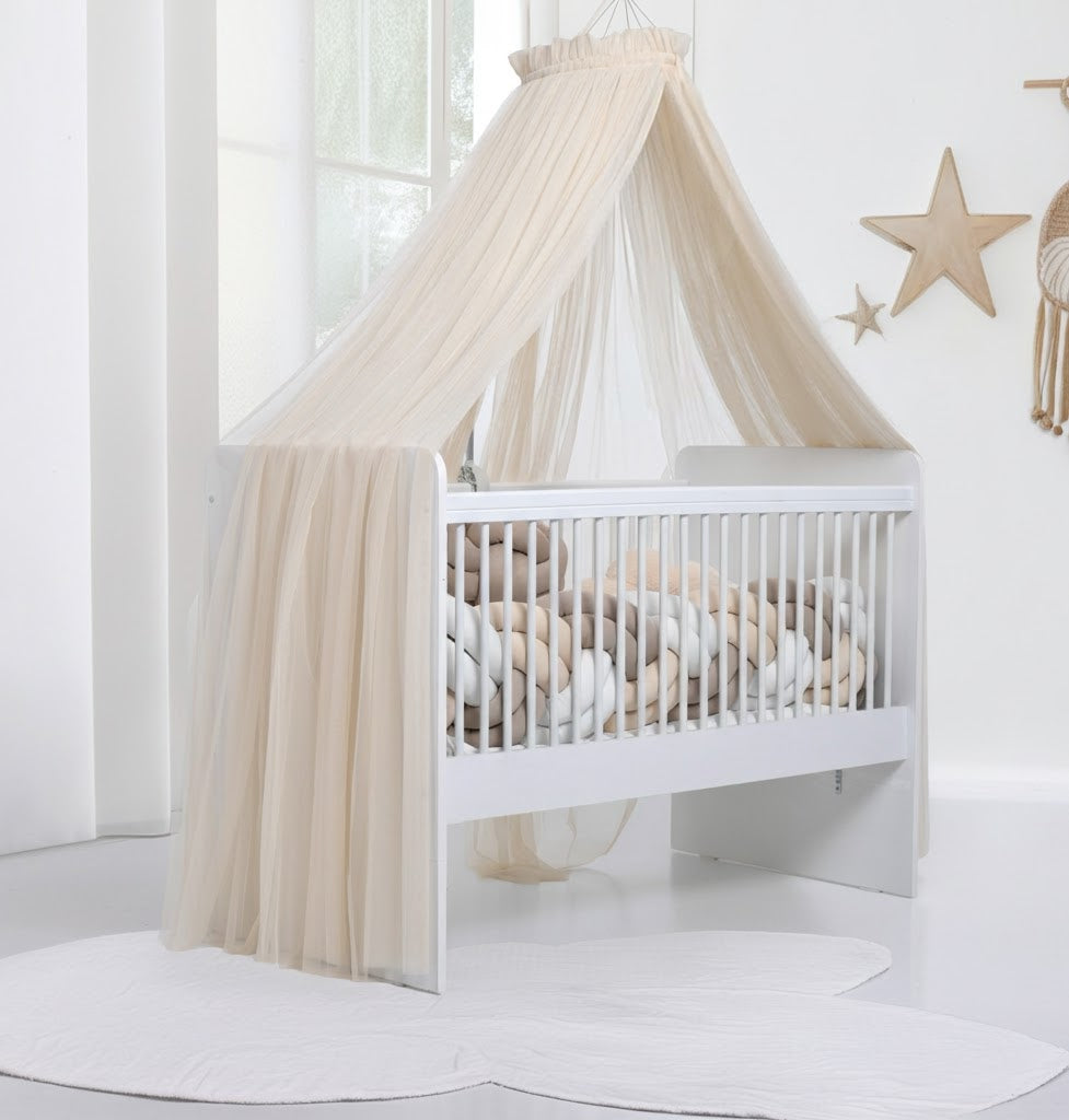 Light beige bed canopy with bobbles