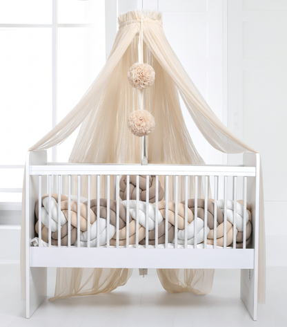 Light beige bed canopy with bobbles