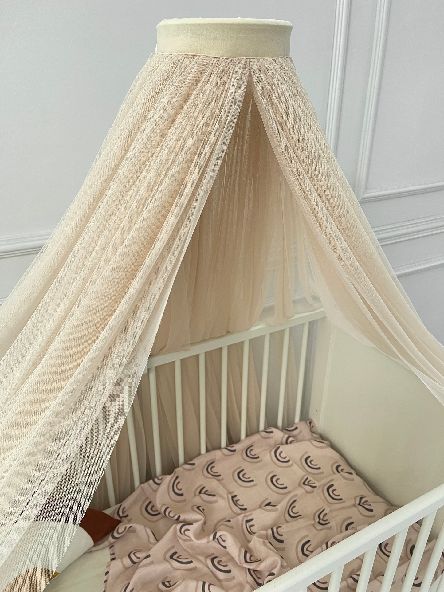 Yellow bed canopy with pompom wreath