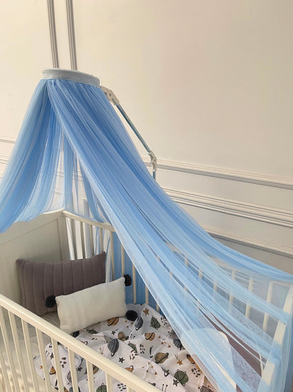 Blue bed canopy with pompom wreath
