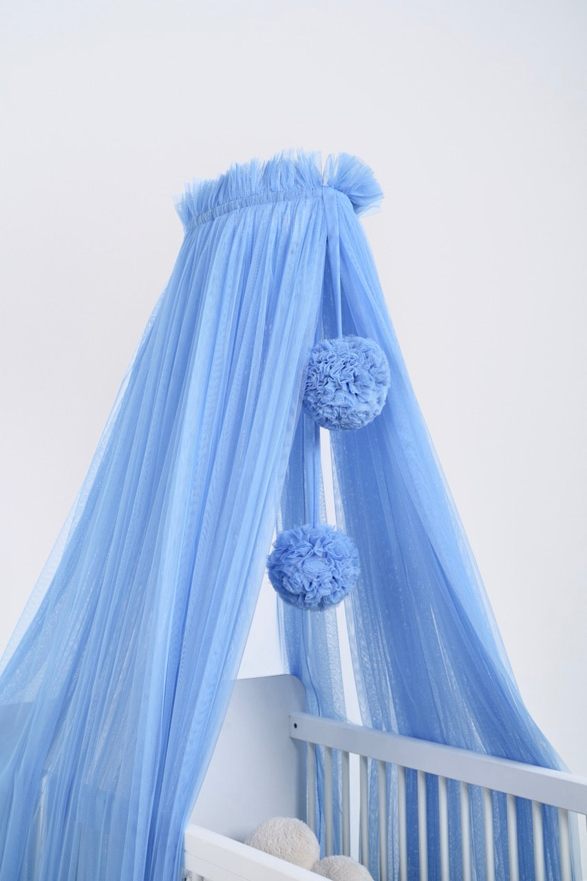 blue bed canopy with pompoms