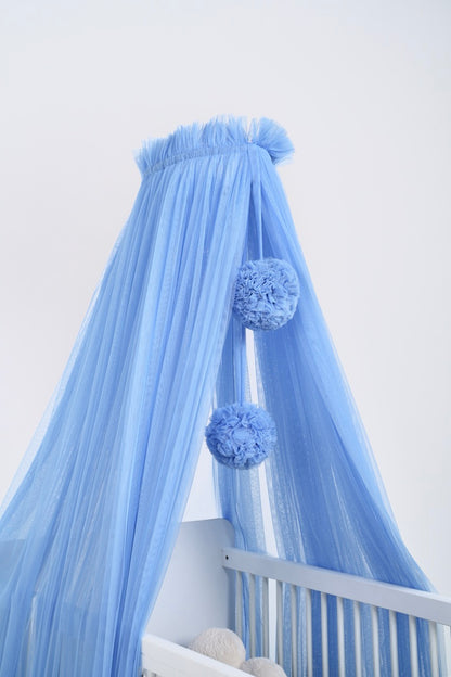 blue bed canopy with pompoms